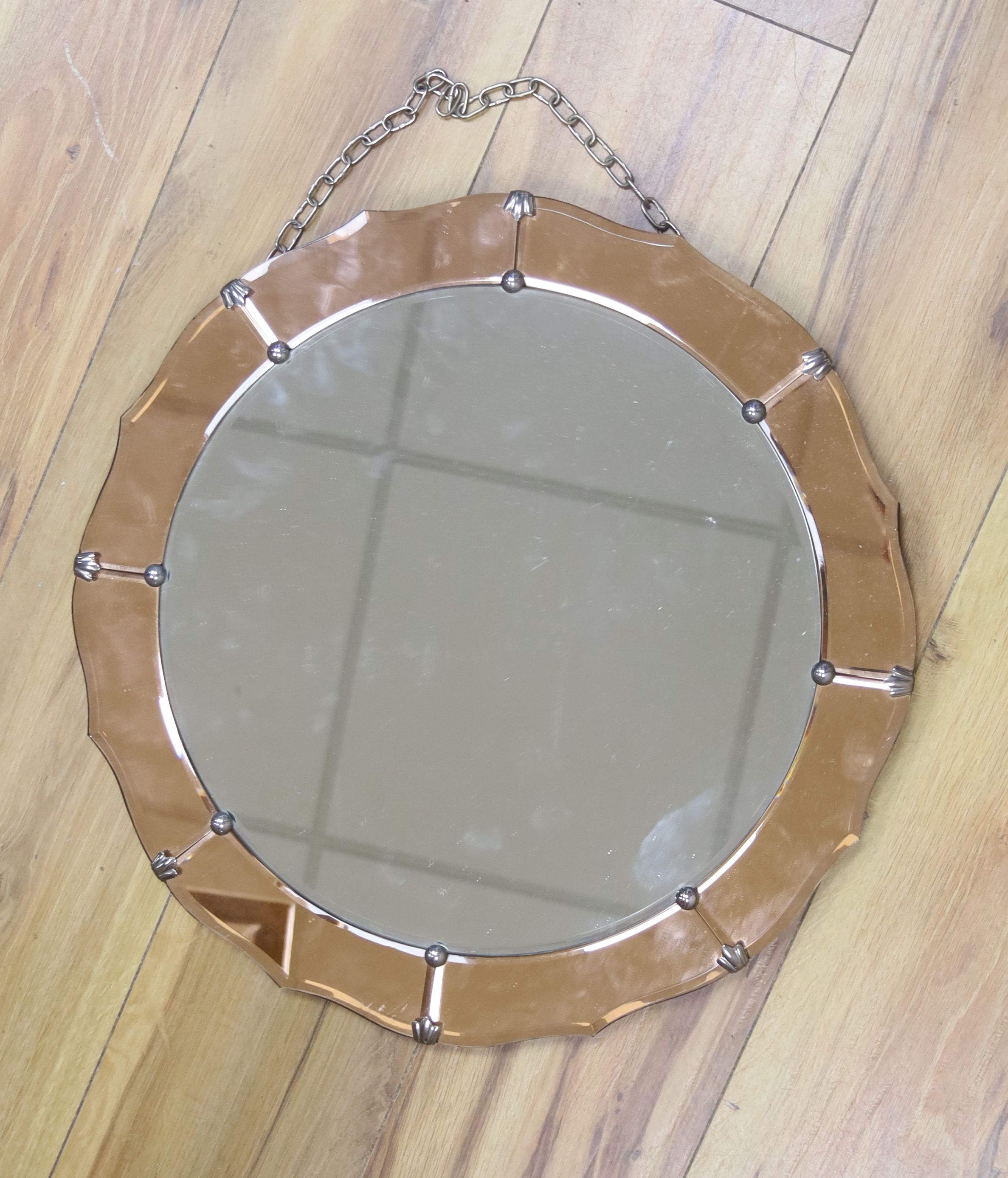 A 1930's tinted glass wall mirror, diameter 46cm